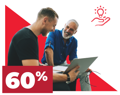 One colleague showing a laptop screen to another colleague who is smiling approvingly.